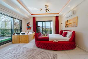 a bedroom with a red bed and a red couch at Villa Bella in Doger Koyu +33 photos