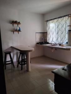 a kitchen with a table and a table and a sink at Cómo en casa in Tizimín