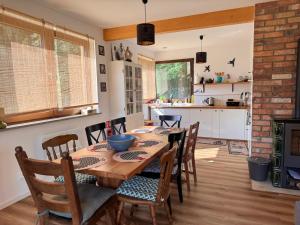a kitchen and dining room with a table and chairs at Przystanek Beztroska in Wydminy
