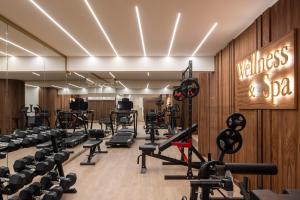 a gym with a lot of treadmills and weights at Anthem Suites & Spa in Athens