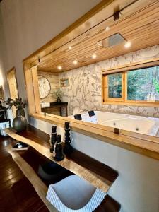 a large bathroom with a tub and a large mirror at Cabañas VIP in Mazamitla +117 photos