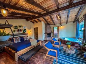 a living room with a bed and a tub at Cabañas VIP in Mazamitla