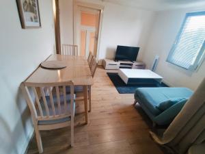 a living room with a table and chairs and a couch at Max-El's Home in Geispolsheim