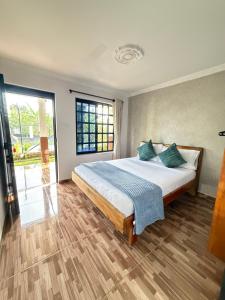 a bedroom with a large bed and a large window at Tangara Real Hotel Campestre in Quimbaya +21 photos