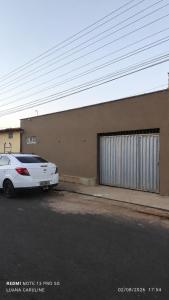 a white car parked in front of a building at Casa Toda com Garagem a 3km do Aeroporto in Teresina
