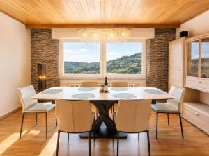 a dining room with a table and chairs and a large window at PMC Traumblick Suite & Spa - Whirlpool & Sauna in Bad Ems