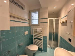 a bathroom with a toilet and a shower at Frontemare in Porto Garibaldi +253 photos