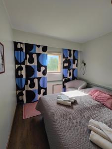 a bedroom with a bed with two towels on it at Wanha Mannila in Savonlinna