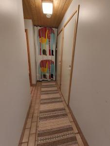 a hallway with a carpet and chairs in a room at Wanha Mannila in Savonlinna