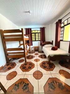 a room with two bunk beds and a tiled floor at Pousada Caminho das Aguas in Lindóia +43 photos