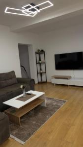 a living room with a couch and a coffee table at Urban Apartment Karpoš in Skopje +3 photos