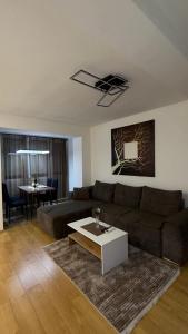 a living room with a couch and a table at Urban Apartment Karpoš in Skopje