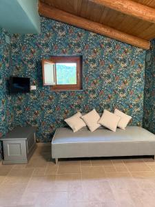 a bedroom with a bed with floral wallpaper at Domus Lauri in Laurino