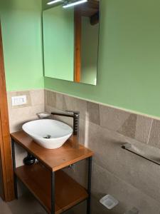 a bathroom with a white sink and a mirror at Domus Lauri in Laurino +21 photos