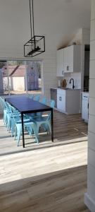 a blue table and chairs in a kitchen at SANDY BEACH Paradise On The Beach in Lincoln Junction +9 photos
