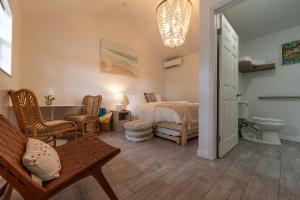 a bedroom with a bed and a bathroom at Seahorse Beach Bungalows in Fort Pierce +144 photos