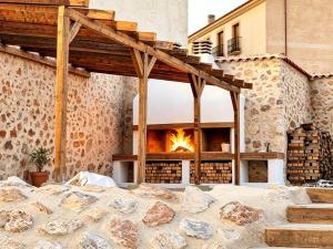 an outdoor fireplace in a building with a fire place at La Serrería-Premium Suite Apartments & Private Jacuzzi in Belmonte
