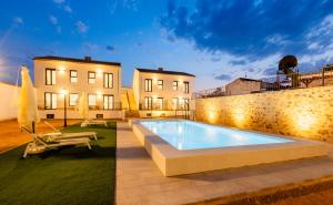 a swimming pool in the backyard of a house at La Serrería-Premium Suite Apartments & Private Jacuzzi in Belmonte