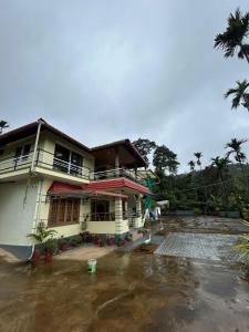 a house with a large yard in front of it at Spatika Villa in Madikeri
