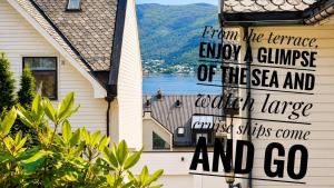 a sign on the side of a house at Bergvegen Guesthouse Aalesund in Ålesund