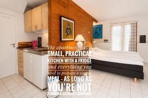 a kitchen with a bed in a room at Bergvegen Guesthouse Aalesund in Ålesund +14 photos
