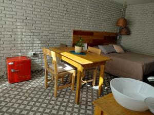 a room with a table and a bed and a desk and chair at Casa Olivia Habitación Privada in Alta Gracia +2 photos