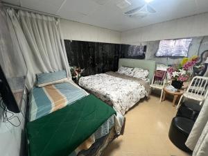 a bedroom with a bed and a chair at Sahara View Guest House Prime Location on the Dubai Sharjah Border in Sharjah