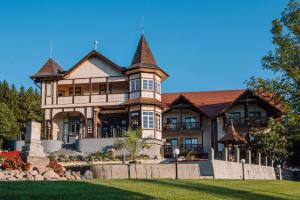a large house with a turret at Vila Bernady Sovata in Sovata