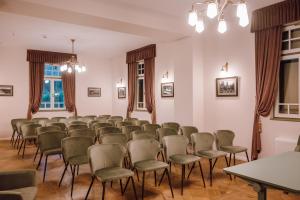 a room with rows of chairs and a table at Vila Bernady Sovata in Sovata