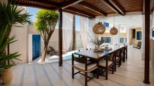 a dining room with a table and chairs at Villa Kallergi Athena in Loutra