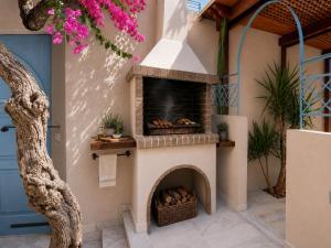 a patio with a pizza oven in a house at Villa Kallergi Athena in Loutra