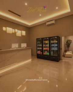 a restaurant with a drink cooler in a room at Hotel Dal Flora in Sorriso