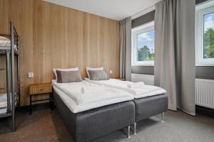 a bedroom with a bed and two windows at Måby Park Hotel Arlanda in Arlanda
