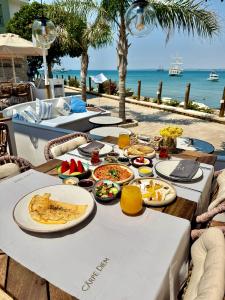 a table with food on it next to the ocean at Nomad Hotel Side - Adults Only in Side