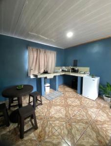 a kitchen with a table and a table and chairs at Casa Colibrí #1 in Puerto Jiménez