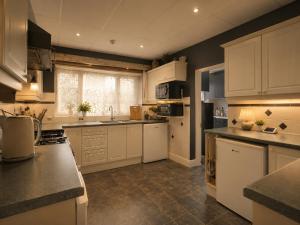 a kitchen with white cabinets and a counter top at Argyle Lodge Self Catering Guest House in Southampton