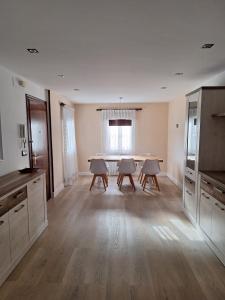 a kitchen with a table and chairs in a room at Casa de la güela in Avilés