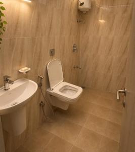 a bathroom with a toilet and a sink at Lodha Crown Premium 2BHK Thane in Thane