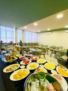 a table with many plates of food on it at Hotel Dal Flora in Sorriso