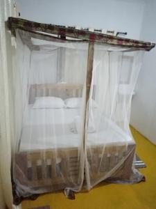 a bed covered in plastic in a room at MafiaSeaview in Kilindoni +15 photos