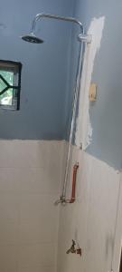 a bathroom with a wall that has been torn up at MafiaSeaview in Kilindoni
