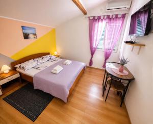 a small bedroom with a bed and a table at Camp Krka in Lozovac +50 photos