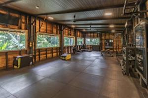 a large room with wooden walls and floors and windows at Carenero Hills - Beach and Surf Bungalows in Bocas Town