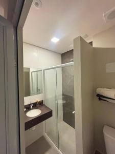 a bathroom with a glass shower and a sink at Hotel Dal Flora in Sorriso +18 photos