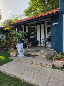 a blue house with a patio in front of it at La Abuela Hospitality in Dorado