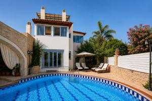 a swimming pool in front of a house at Villa Kallergi Nefeli in Loutra