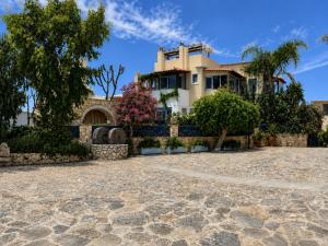 a house with a stone driveway in front of it at Villa Kallergi Nefeli in Loutra