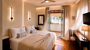 a bedroom with a bed and a sliding glass door at Villa Kallergi Nefeli in Loutra +43 photos