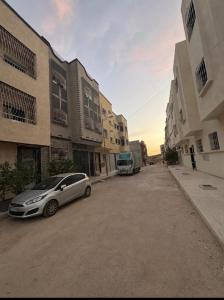 a car parked on a street next to some buildings at Appart Hidaya in Fez
