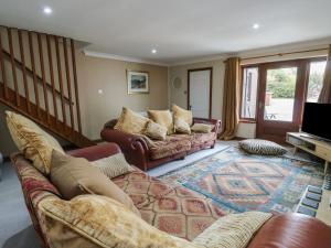 a living room with two couches and a television at Ty Haf in Holyhead